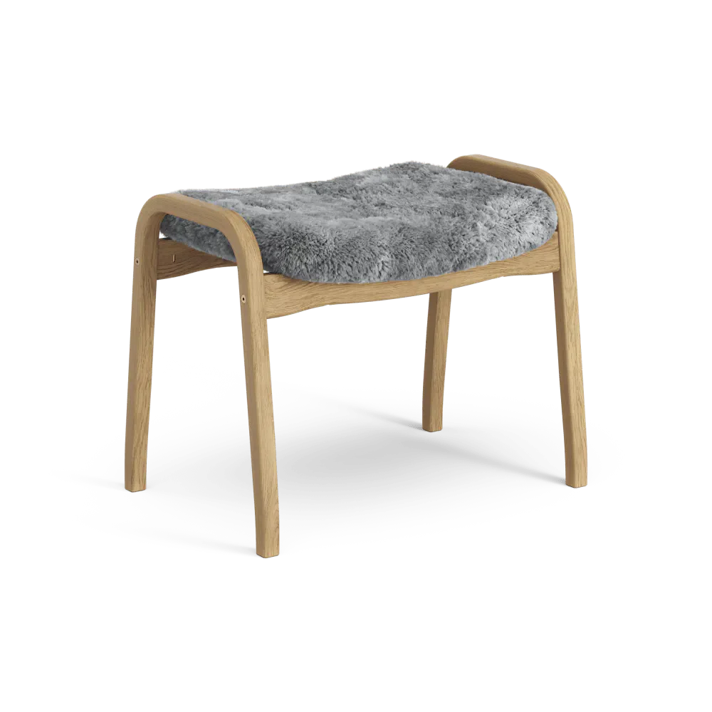 Lamino-Fußhocker | Swedese | Lundia Living: Mit einem hellen Holzrahmen und einem weichen, grauen Schaffellbezug für bequeme Entspannung