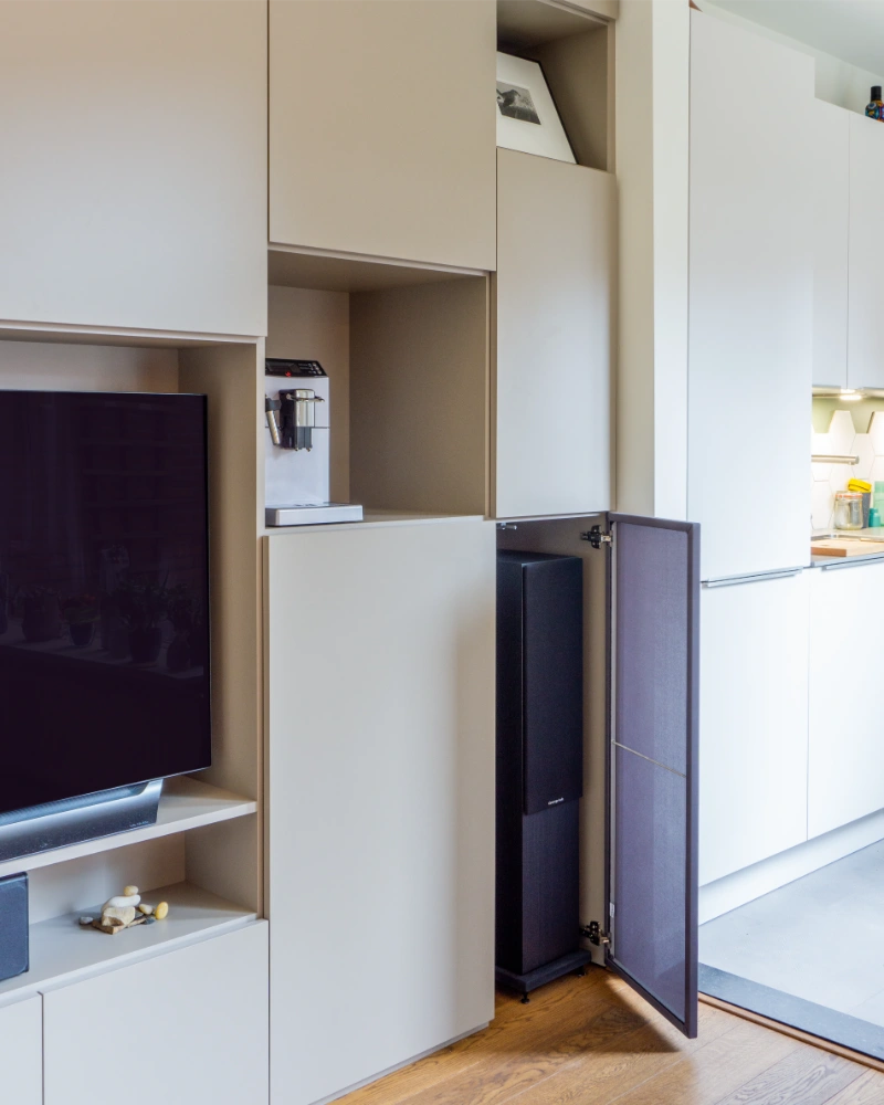 Speelse crèmekleurige tv-wandkast op maat van Lundia met open speakerkast